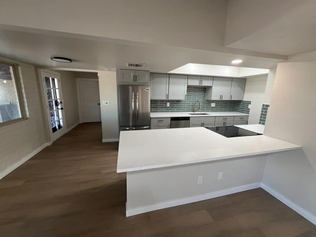 Bright and airy kitchen renovation with stainless appliances and white countertops by Kat Remodeling in Southern Arizona
