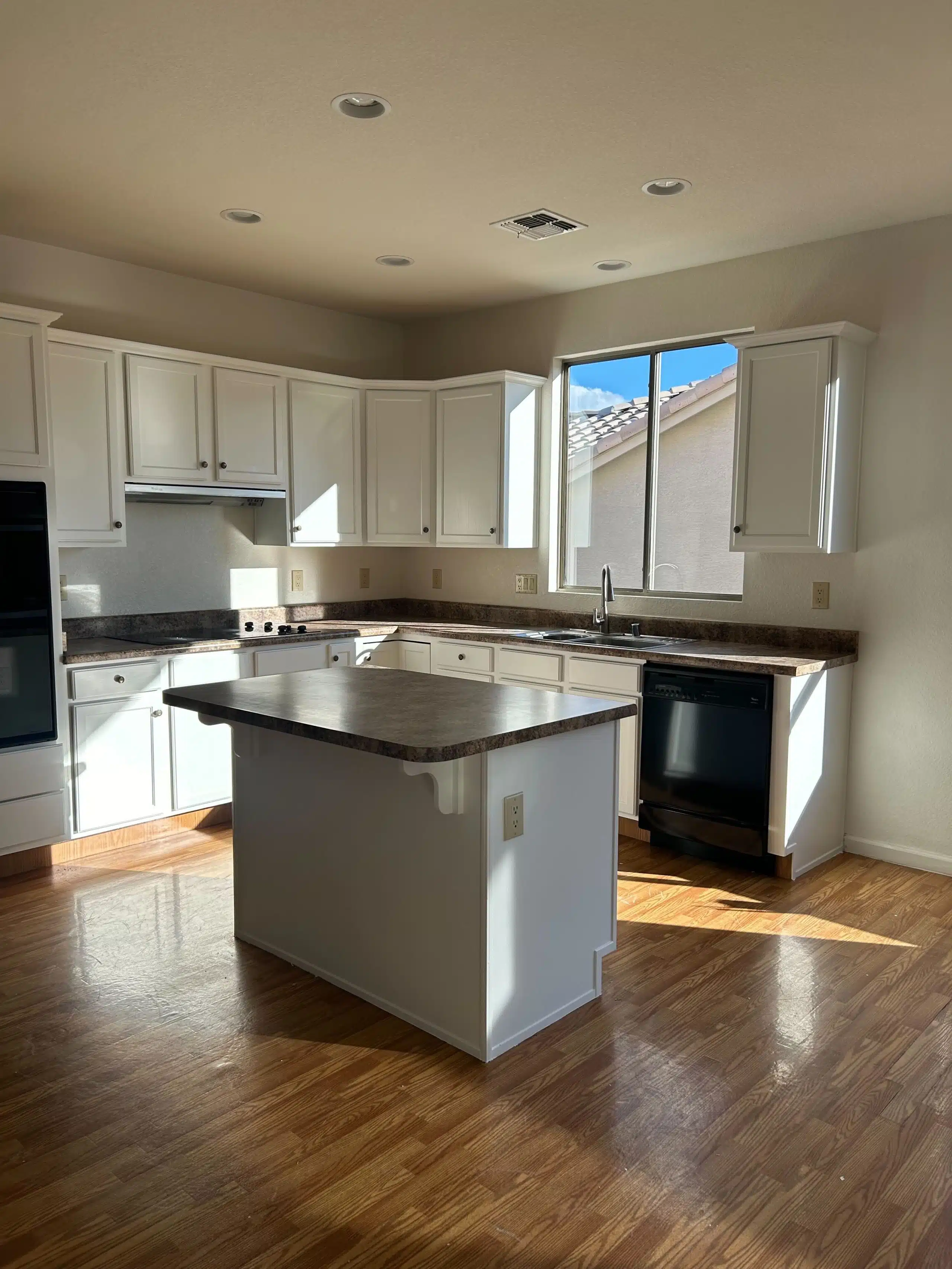 Sunlit kitchen renovation featuring center island and laminate countertops – Kat Remodeling in Southern Arizona